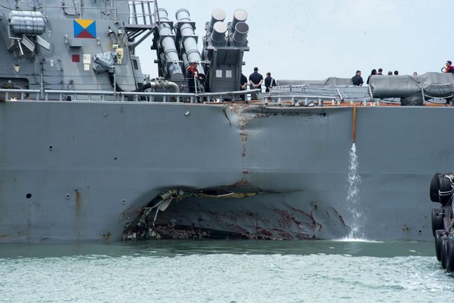 Damage to the portside is visible as the Guided-missile destroyer USS John S. McCain (DDG 56) steers towards Changi naval base in Singapore following a collision with the merchant vessel Alnic MC Monday, Aug. 21, 2017. The USS John S. McCain was docked at Singapore's naval base with "significant damage" to its hull after an early morning collision with the Alnic MC as vessels from several nations searched Monday for missing U.S. sailors. (Mass Communication Specialist 2nd Class Joshua Fulton/U.S. Navy photo via AP)