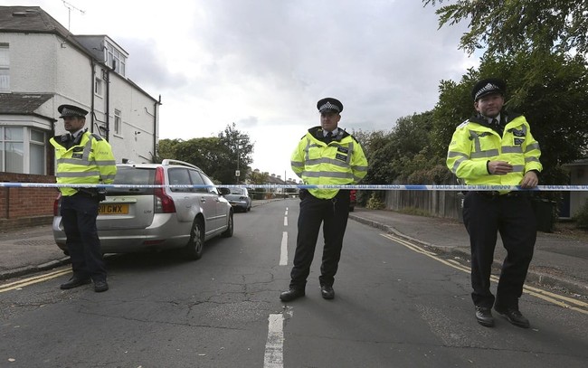 Police officers secure a road in Sunbury-on-Thames, southwest London, as part of the investigation into Friday's Parsons Green bombing, Saturday Sept, 16, 2017. British police made what they called a "significant" arrest Saturday in southern England, and searched a property in Sunbury-on-Thames as the manhunt for suspects continues following the partially exploded bomb attack on the London subway. ( Jonathan Brady/PA via AP)