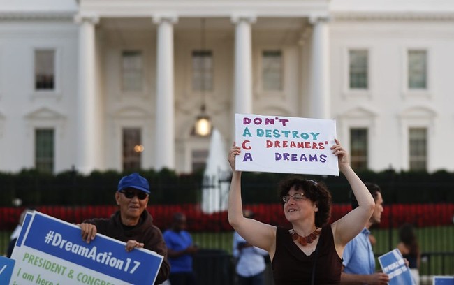 Julia Paley, of Arlington, Va., with the DMV Sanctuary Congregation Network, dances with a sign that reads "DACA Don't Destroy Dreamers Dreams" during a rally supporting Deferred Action for Childhood Arrivals, or DACA, outside the White House, in Washington, Monday, Sept. 4, 2017. A plan President Donald Trump is expected to announce Tuesday for young immigrants brought to the country illegally as children was embraced by some top Republicans on Monday and denounced by others as the beginning of a "civil war" within the party. (AP Photo/Carolyn Kaster)
