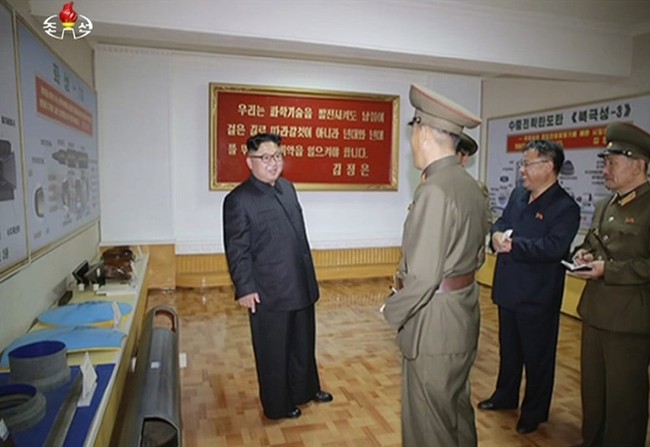 In this image made from video of a news bulletin aired by North Korea's KRT on Wednesday, Aug. 23, 2017, leader Kim Jong Un visits the Chemical Material Institute of Academy of Defense Science at an undisclosed location in North Korea. North Korea's state media released photos that appear to show concept diagrams of the missiles hanging on a wall behind leader Kim Jong Un, one showing a diagram for a missile called "Pukguksong-3." Independent journalists were not given access to cover the event depicted in this photo. (KRT via AP Video)